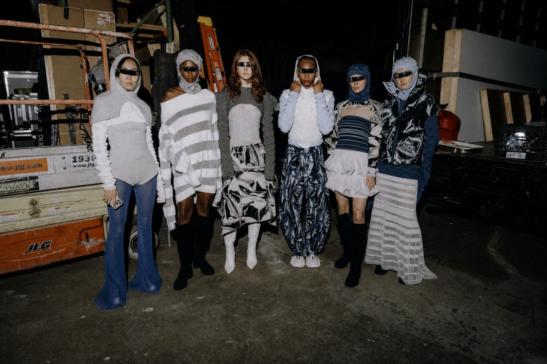 Six models backstage in striped and printed knitwear from the collection